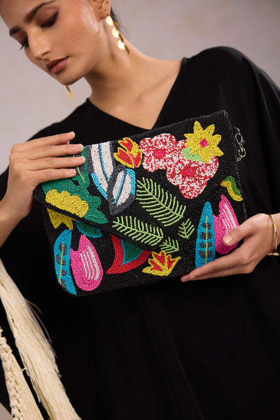 Black beaded clutch bag showcasing a black boho clutch for women styled as a premium black fabric bag for ethnic wear.