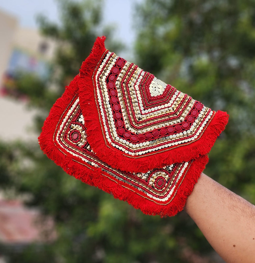 Red beaded fabric clutch bag showcasing a red boho clutch for women styled as a premium red ethnic evening purse.