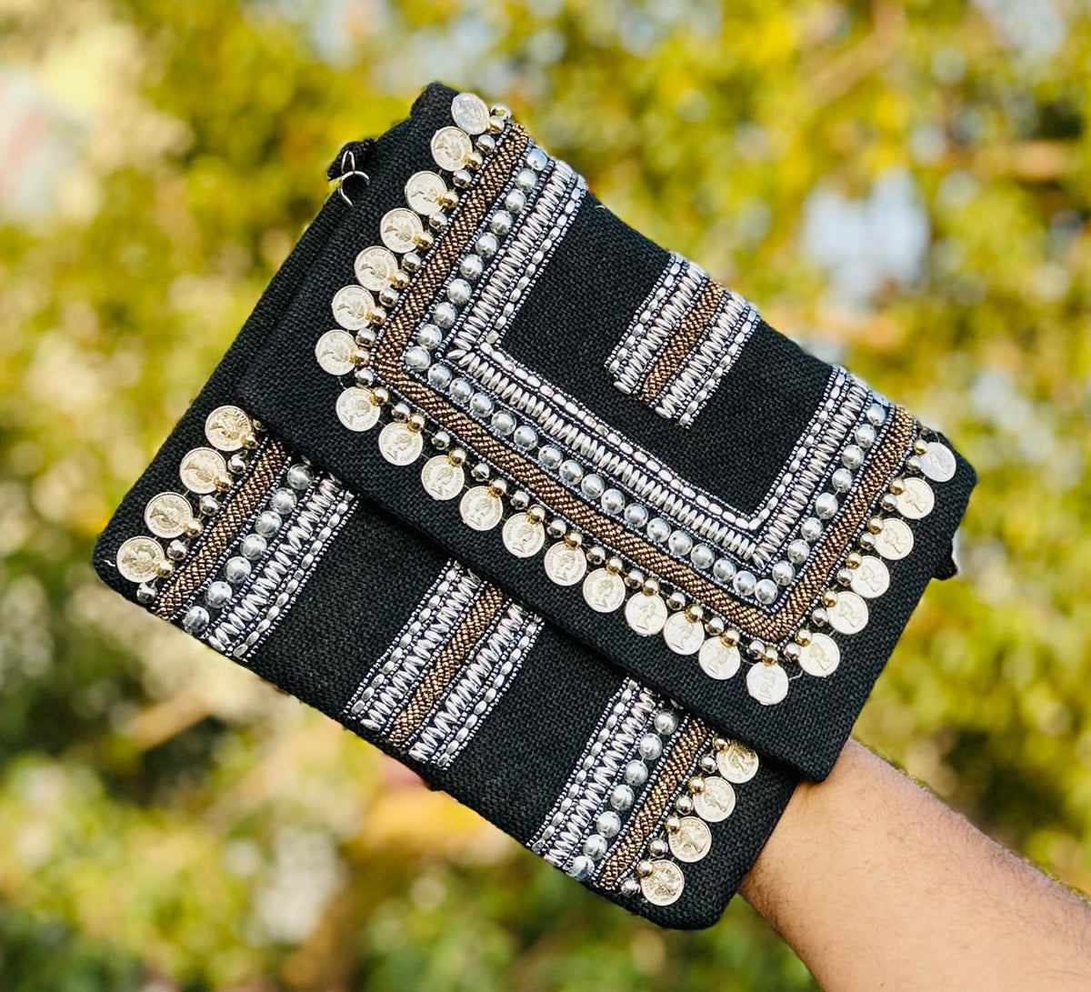 Silver beaded clutch bag showcasing a silver fabric clutch bag styled as an evening clutch bag for vacation looks.